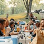 a group of people sitting around a picnic table